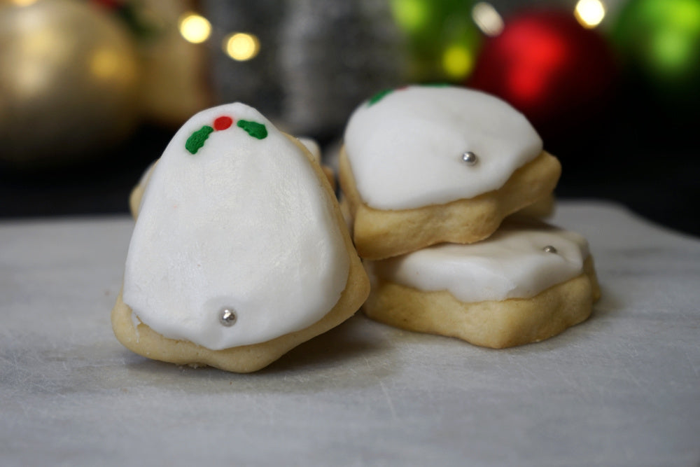 Sugar bell-shaped Christmas cookie with white frosting.
